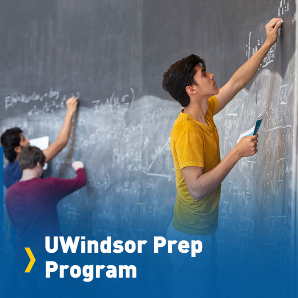 Students writing on chalkboard