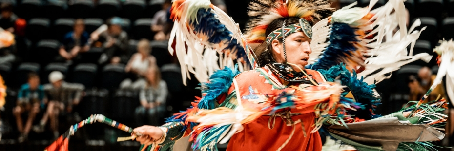 Indigenous person engaging in Powwow dance