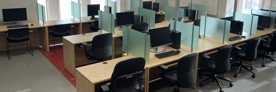 testing centre interior with rows of desks and computers