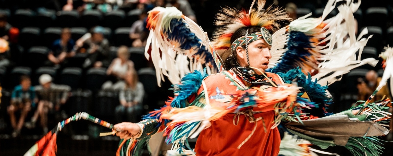 Indigenous person engaging in Powwow dance